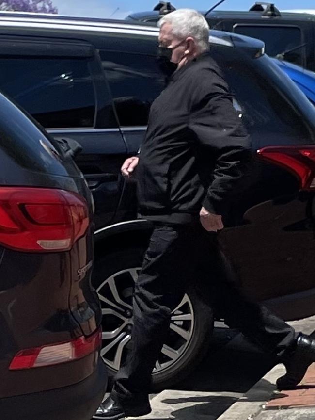 John Casey puts on a face mask on as he walks out of Lismore Courthouse during the trial.