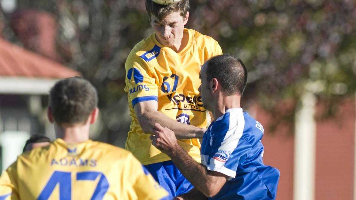 USQ&#39;s Keegan Dixon heads the ball away during his side&#39;s FFA Cup game at the weekend. Picture: Nev Madsen