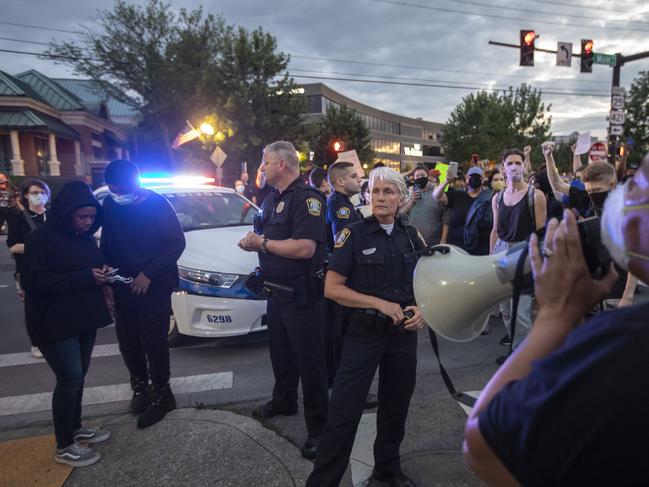 Protesters calling for an end to police violence stand in the intersection of Main Street and Midland Avenue in downtown Lexington, Kentucky. Picture: Ryan C. Hermens/Lexington Herald-Leader via AP