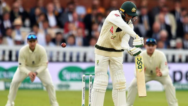 Usman Khawaja edges to the wicketkeeper. Photo by Glyn KIRK / AFP