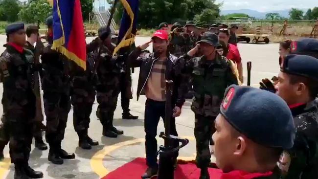 Manny Pacquiao is given a military guard of honour as he boards his flight for Australia.
