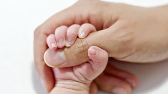 Hands of a newborn baby with the nails, holding his mothers hand.  CREDIT istock image