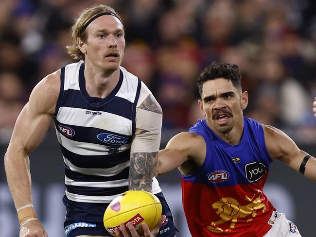 MELBOURNE, AUSTRALIA - SEPTEMBER 16: Tom Stewart of the Cats handballs during the AFL First Preliminary match between the Geelong Cats and the Brisbane Lions at Melbourne Cricket Ground on September 16, 2022 in Melbourne, Australia. (Photo by Darrian Traynor/AFL Photos/Getty Images)
