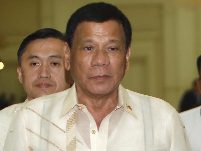 FILE - In this Dec. 14, 2016 file photo, Philippine President Rodrigo Duterte arrives for a meeting in Phnom Penh, Cambodia. The U.S. said Thursday, Dec. 15, 2016, it is withholding a major aid package to the Philippines and is deeply troubled by a boast from the nation's leader that he used to drive around looking for criminals to kill. (AP Photo/Heng Sinith, File)