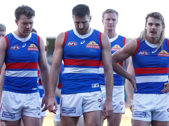 LAUNCESTON, AUSTRALIA - AUGUST 13: (L-R) Jack McRae, Marcus Bontempelli and Bailey Smith of the Bulldogs look dejected after a loss during the 2023 AFL Round 22 match between the Hawthorn Hawks and the Western Bulldogs at University of Tasmania Stadium on August 13, 2023 in Launceston, Australia. (Photo by Michael Willson/AFL Photos via Getty Images)