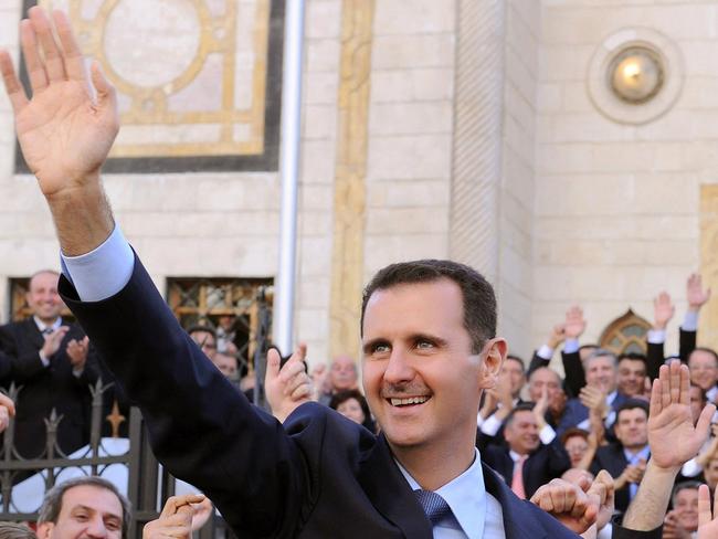 Deposed Syrian President Bashar al-Assad waving at supporters after addressing parliament in Damascus on March 30, 2011. Picture: AFP