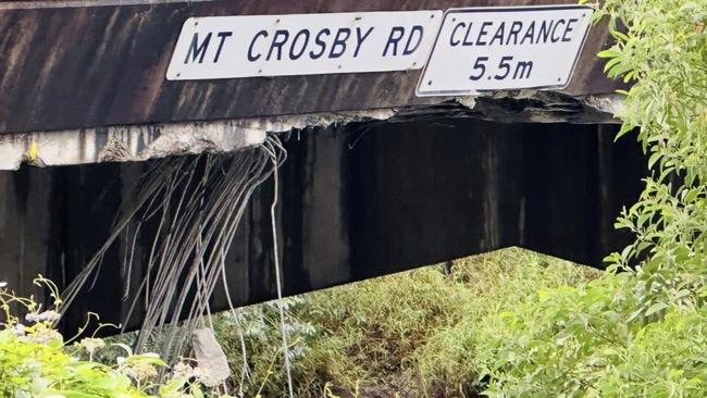 The Warrego Highway overpass was hit on the height warning sign.