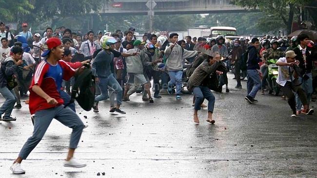 Rival high school boys engage in a prearranged battle, or <i>tawuran</i>, in west Jakarta, Indonesia, last month.