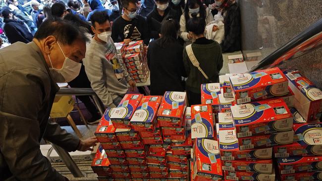 Citizens line up to buy face masks in Hong Kong, despite medical experts' advice that most people who aren't sick don't need to wear them. Picture: AP