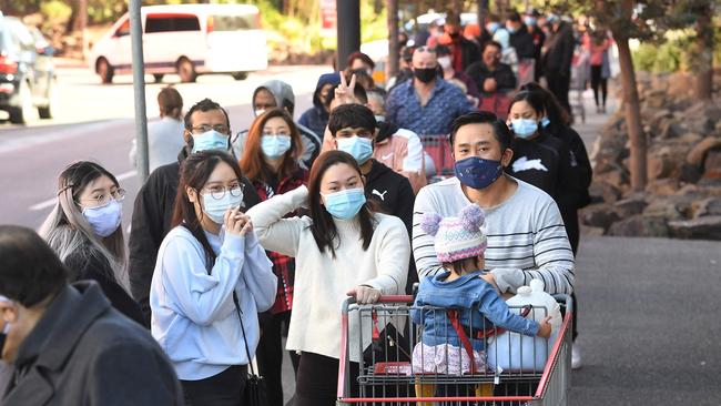 Shoppers wait in a long queue outside a Costco outlet in Melbourne