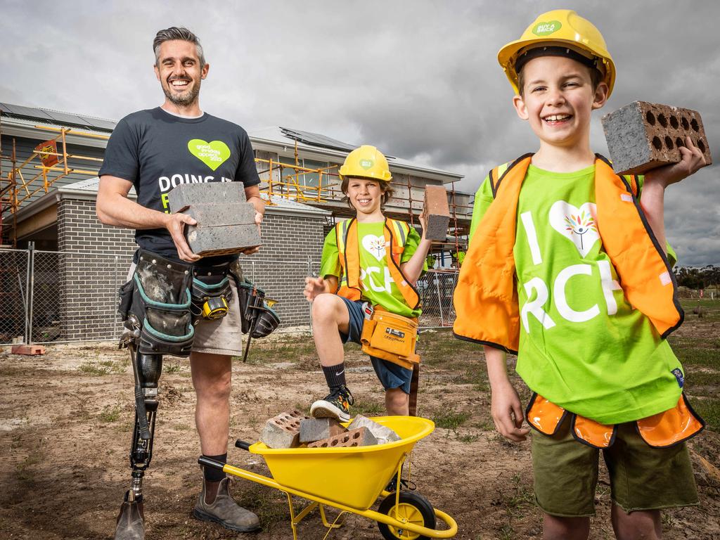 Good Friday Appeal Charity home. Buy A Brick launch. Henley site supervisor, Billy Ferguson, now 37, who spent more than 16 years as a patient at the Royal ChildrenÃs Hospital after being born without a leg is joined by his sons Levi 10, and Charlie 7, at the RCH home construction site in Sunbury. Picture: Jake Nowakowski
