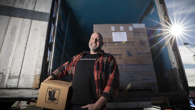 Nick Haddow from Bruny Island Cheese at his North Hobart shop with his shipment of 30 wine cases and 80 beer cases bound for Japan. Picture Chris Kidd