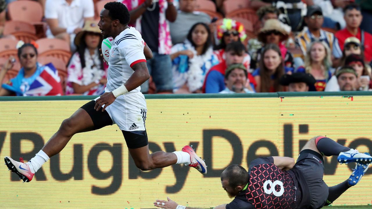 USA’s Carlin Isles beats the tackle from England’s Tom Bowen at Waikato Stadium.