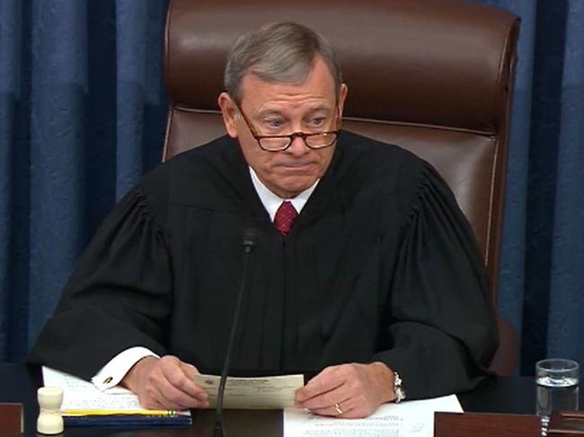 US Supreme Court Chief Justice John Roberts reading a question from a Senator during the impeachment trial in the Senate Chamber at the US Capitol. Picture: AFP