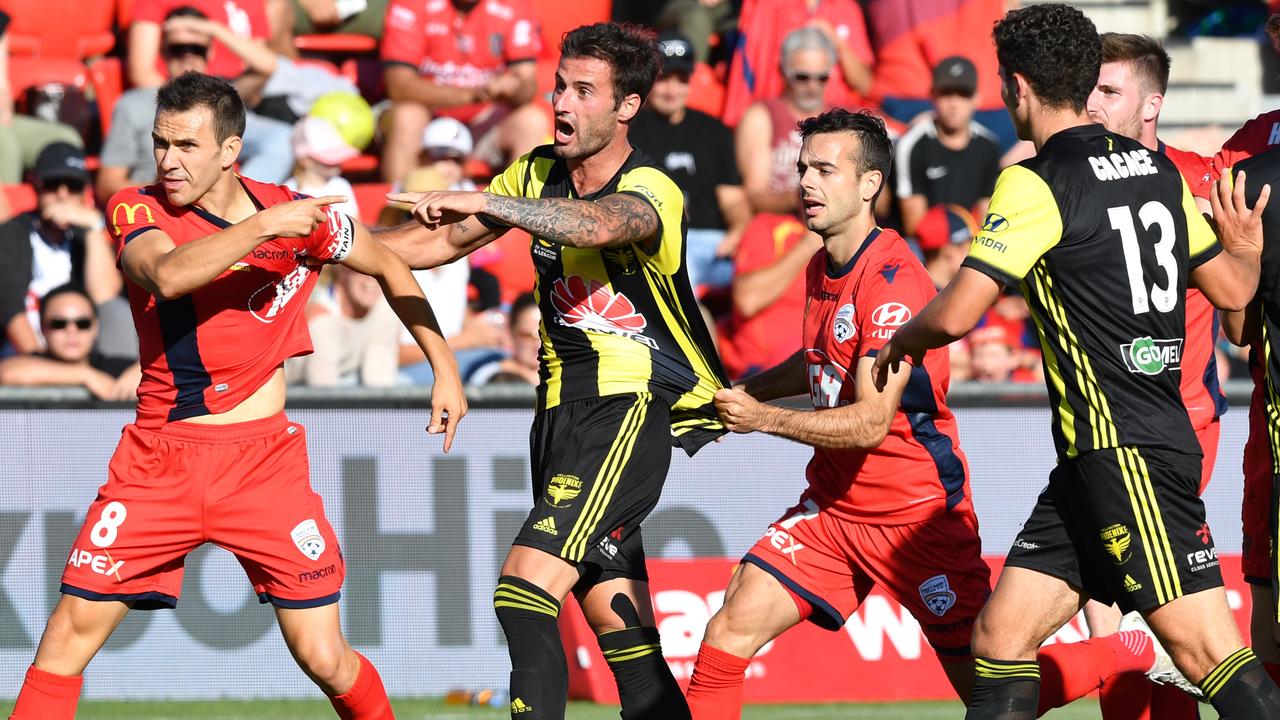 Isaias of Adelaide, left, and Mandi of the Phoenix react after the red-card incident. Picture: AAP Image/David Mariuz