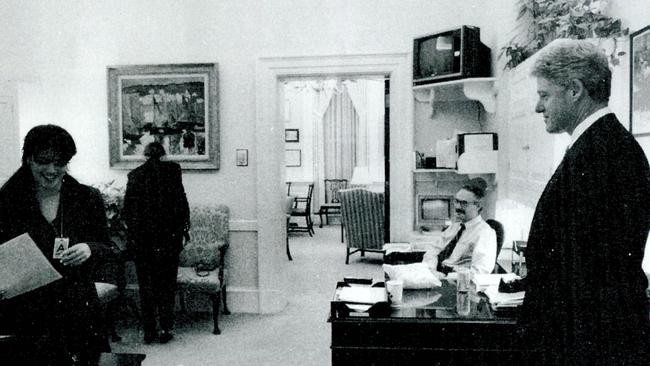 Former White House intern Monica Lewinsky works in a White House office as President Bill Clinton looks on. The photo was submitted as evidence in documents by the Starr investigation and released by the House Judiciary committee.