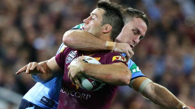 Cooper Cronk of QLD taken high by James Maloney of NSW during the 2nd State of Origin game between Queensland and New South Wales. Pic Darren England.