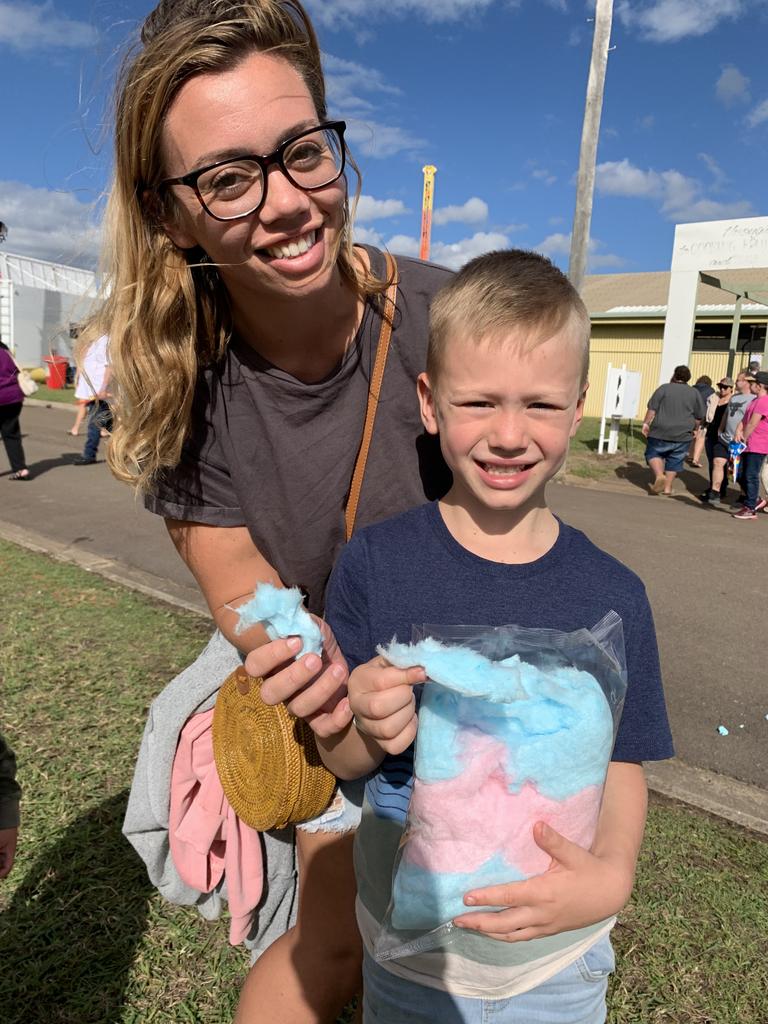 Isobel Slavin and son William Anderson from Hervey Bay tuck in to fairy floss at the Fraser Coast Ag Show for 2021. Photo: Stuart Fast