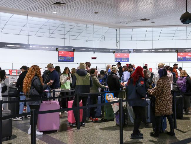 Passengers queue at Melbourne Airport. Picture: Ian Currie