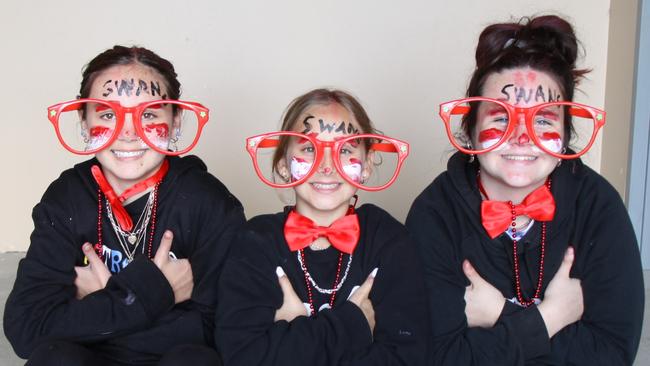 FABULOUS FANS: At Oakes oval, Lismore, Ballie; lie Welch, 11, Amelia Brian, 12, and Payton Schafer, 12, dressed up to cheer on the Swans against Sawtell during the Sir Doug Nicholls Round, May 28, 2021. Photo: Alison Paterson