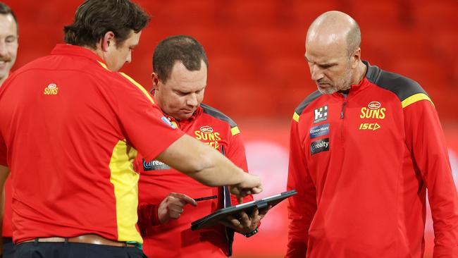 Josh Francou chats with Suns coach Stuart Dew.