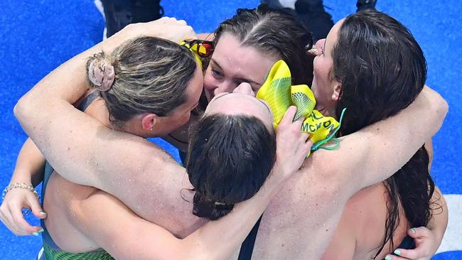 The Aussie team embraces after the race.