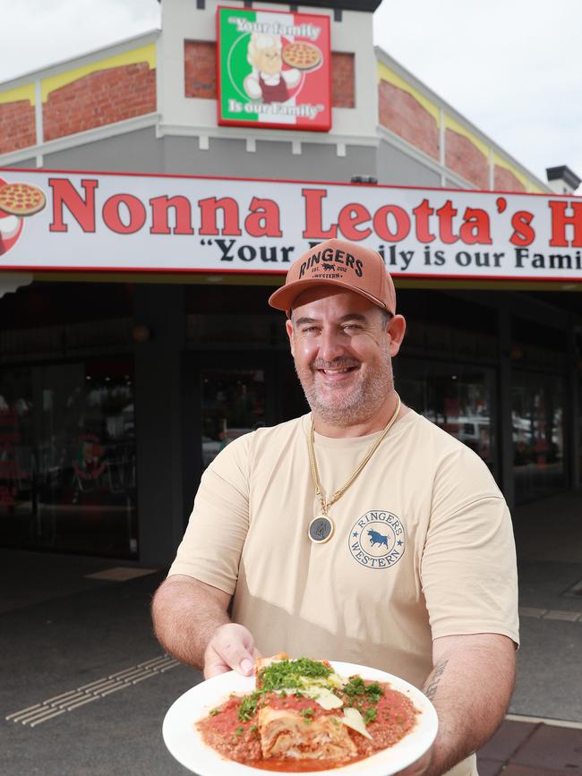 Nonna Leotta's co owner Shane Shroj, serves up a large plate of lasagne at the new restaurant, on the corner of Sheridan and Shields streets. Picture: Brendan Radke