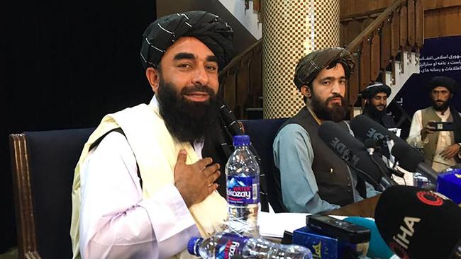 Taliban spokesman Zabihullah Mujahid, left, at the first press conference in Kabul. Picture: AFP