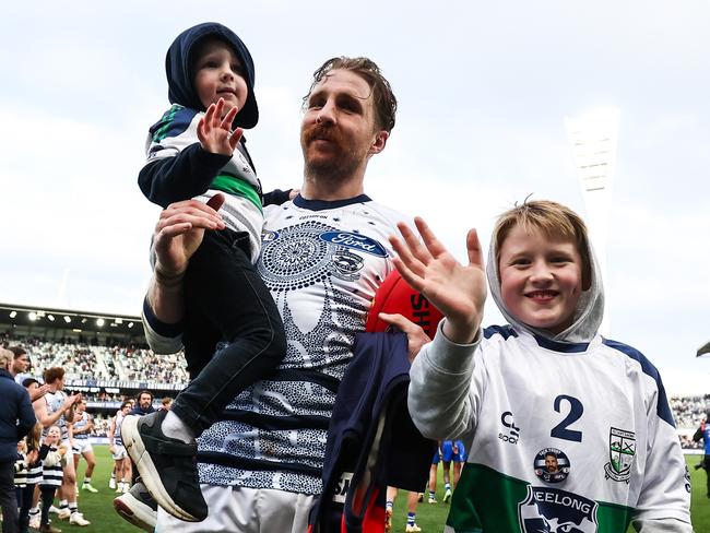 GEELONG, AUSTRALIA - JULY 09: Zach Tuohy of the Cats receives a guard of honour as he leaves the field with his children Flynn and Rafferty during the 2023 AFL Round 17 match between the Geelong Cats and the North Melbourne Kangaroos at GMHBA Stadium on July 9, 2023 in Geelong, Australia. (Photo by Dylan Burns/AFL Photos via Getty Images)