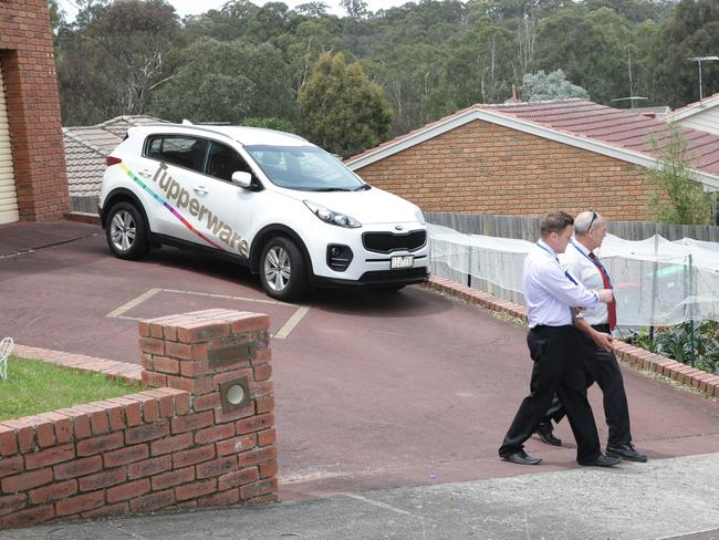 Police leave the house. Picture: Andrew Tauber