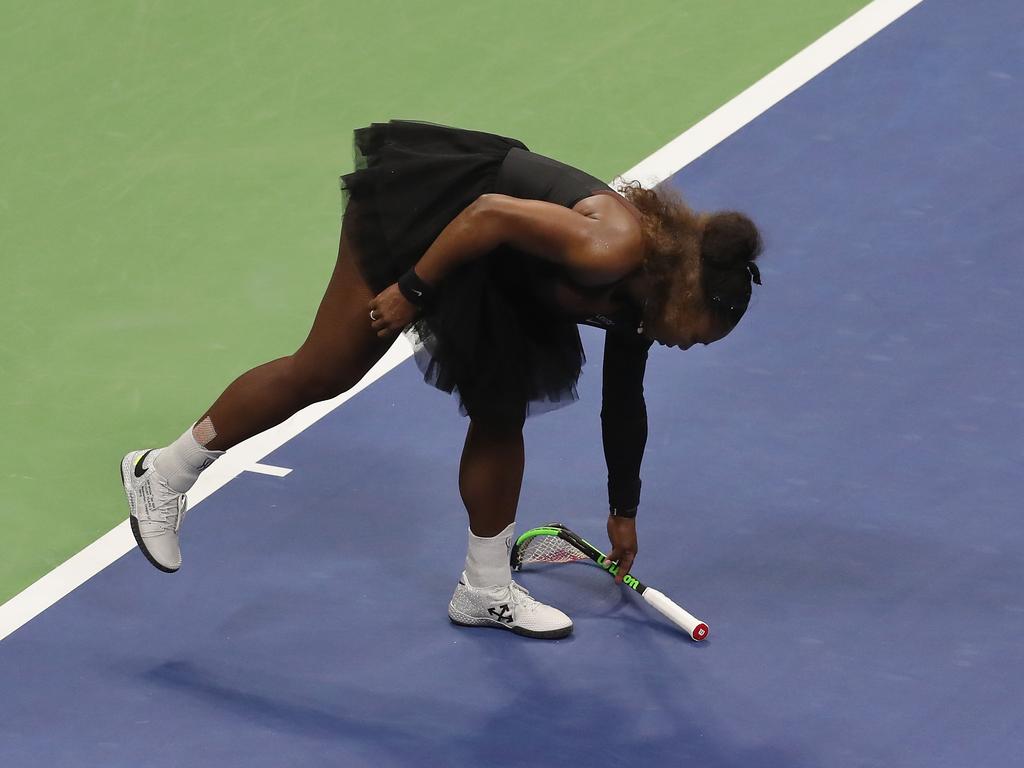 Williams picks up her broken racket. (Photo by Jaime Lawson/Getty Images for USTA)