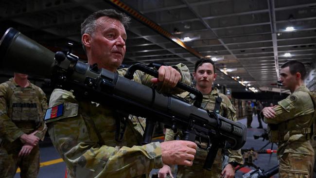 Lt. Gen. Greg Bilton, Commander of Joint Operations of the Australian Defence Force holds a Carl Gustav rocket launcher, aboard HMAS Canberra off Palawan. Picture: AFP