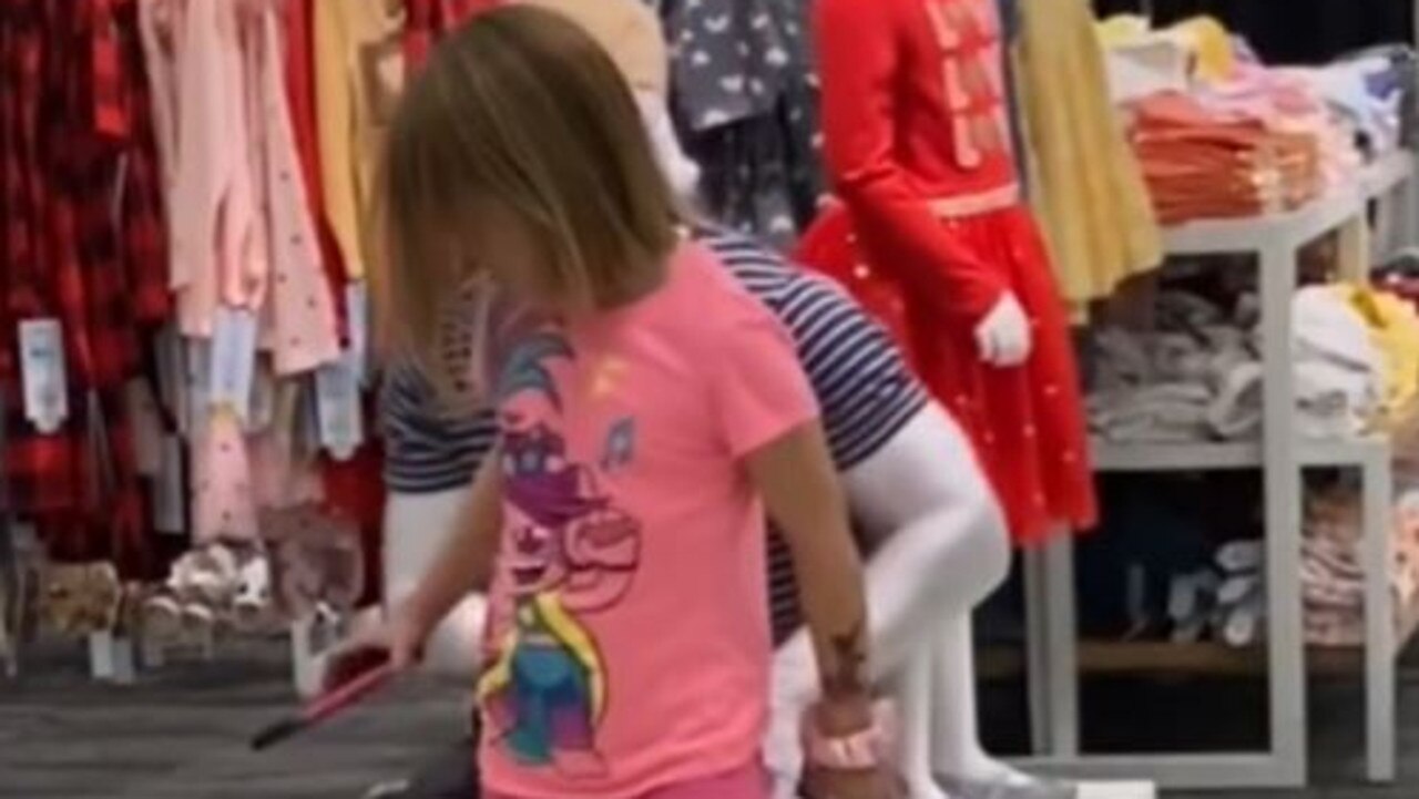 The little girl attempts to sit on the living mannequin’s lap. Picture: TikTok/tugreckless