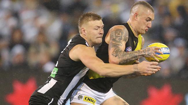 Richmond’s Dustin Martin tries to break the tackle of Jordan De Goey. Pic: Michael Klein