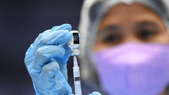 A medical worker prepares Pfizer vaccine dose. Picture: Ted Aljibe/AFP