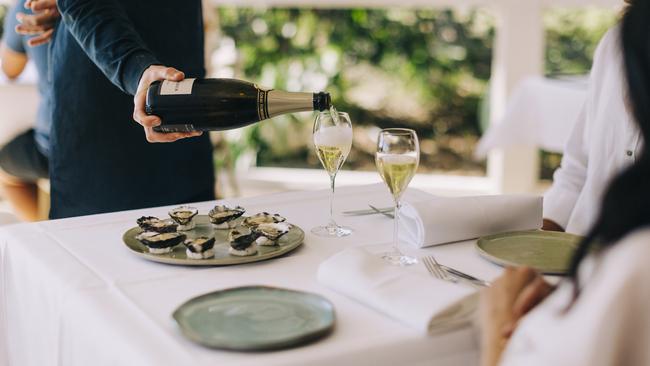 Couple enjoying food and drink at Beach Byron Bay, Byron Bay. Picture: Destination NSW