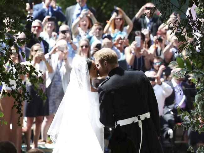 The crowd watched on as the newlyweds engaged in some PDA on the steps of St George's Chapel. Picture: AP