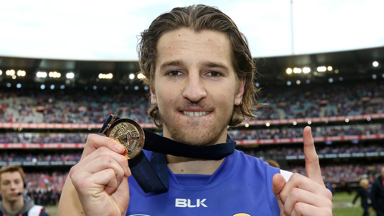 Marcus Bontempelli holds up his 2016 Premiership Medal. Picture: Michel Klein