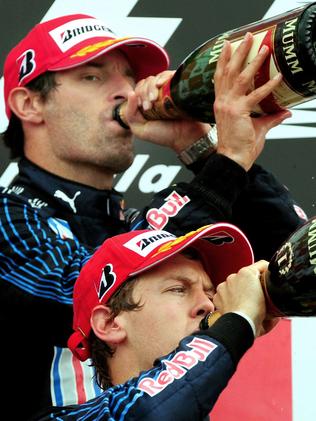 Red Bull driver Sebastian Vettel of Germany, front, winner, drinks champagne with second placed teammate Red Bull driver Mark Webber of Australia on the podium of the British Formula One Grand Prix in 2009.  Picture:  AP