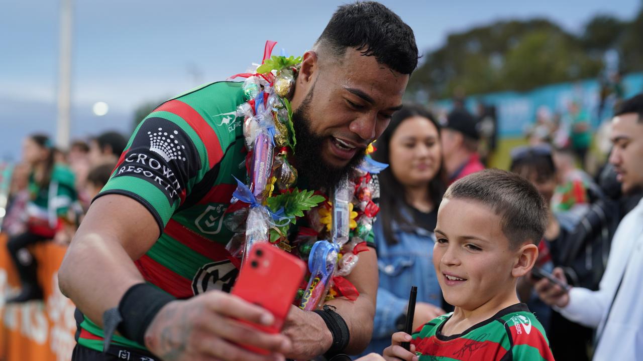 Izaac Thompson takes a photo with a young fan. Credit: Matt Williams