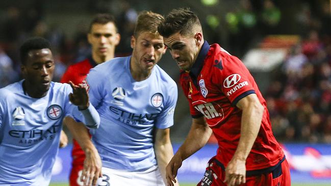 Former Adelaide United defender Ben Garuccio taking on current Red Stefan Mauk during his time at Melbourne City at Coopers Stadium, with ex-Reds player Bruce Kamau (left). Picture: Sarah Reed