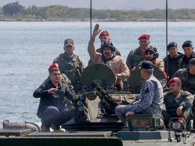 Handout picture released by the Venezuelan presidency showing Venezuela's President Nicolas Maduro (C), his wife Cilia Flores (R at centre) and commanders disembarking in an amphibious vehicle during military exercises at the Naval Base Agustin Armario in Puerto Cabello, Carabobo State, Venezuela, on January 27, 2019. - Maduro on Sunday rejected a European ultimatum that he call elections as opposition rival Juan Guaido stepped up appeals to the military to turn against the leftist government. (Photo by HO / Venezuelan Presidency / AFP) / RESTRICTED TO EDITORIAL USE - MANDATORY CREDIT "AFP PHOTO / VENEZUELAN PRESIDENCY" - NO MARKETING NO ADVERTISING CAMPAIGNS - DISTRIBUTED AS A SERVICE TO CLIENTS