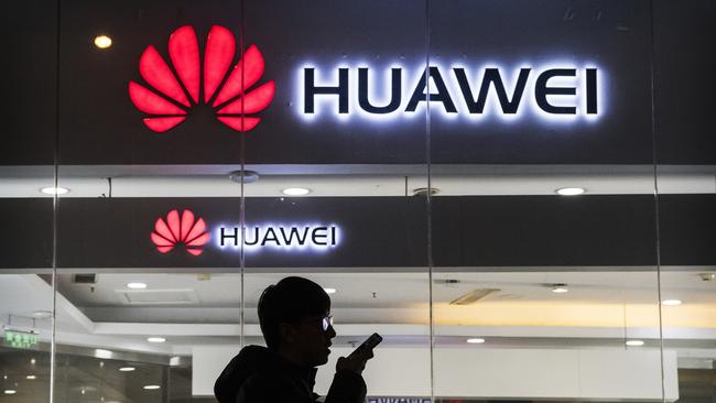 BEIJING, CHINA - JANUARY 29: A pedestrian talks on the phone while walking past a Huawei Technologies Co. store on January 29, 2019 in Beijing, China. The U.S. Justice Department filed a host of criminal charges against Chinese telecoms giant Huawei and its chief financial officer, Meng Wanzhou, including bank fraud, violating sanctions on Iran, and stealing robotic technology. Huawei denied committing any of the violations and rejected criminal claims against Meng, the daughter of Huawei founder Ren Zhengfei, who was arrested in Canada in December last year. (Photo by Kevin Frayer/Getty Images)