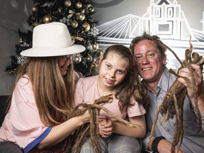 Shannon and Joel Anderson with their daughter Charlise after Joel's dreadlocks are cut off in a fundraiser for Charlise at the Blue Mountain Hotel, Saturday, November 23, 2024. Picture: Kevin Farmer