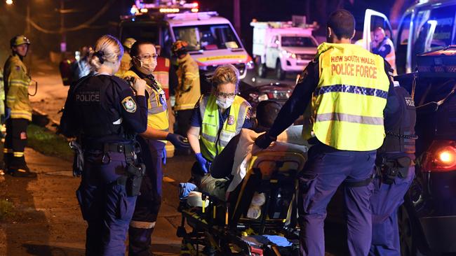 Paramedics take an injured teenager to hospital. Picture: Gordon McComiskie