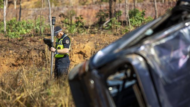 NT Police mark out the scene on the Stuart Hwy in front of the crash wreckage at Manton Dam. Picture: Floss Adams.