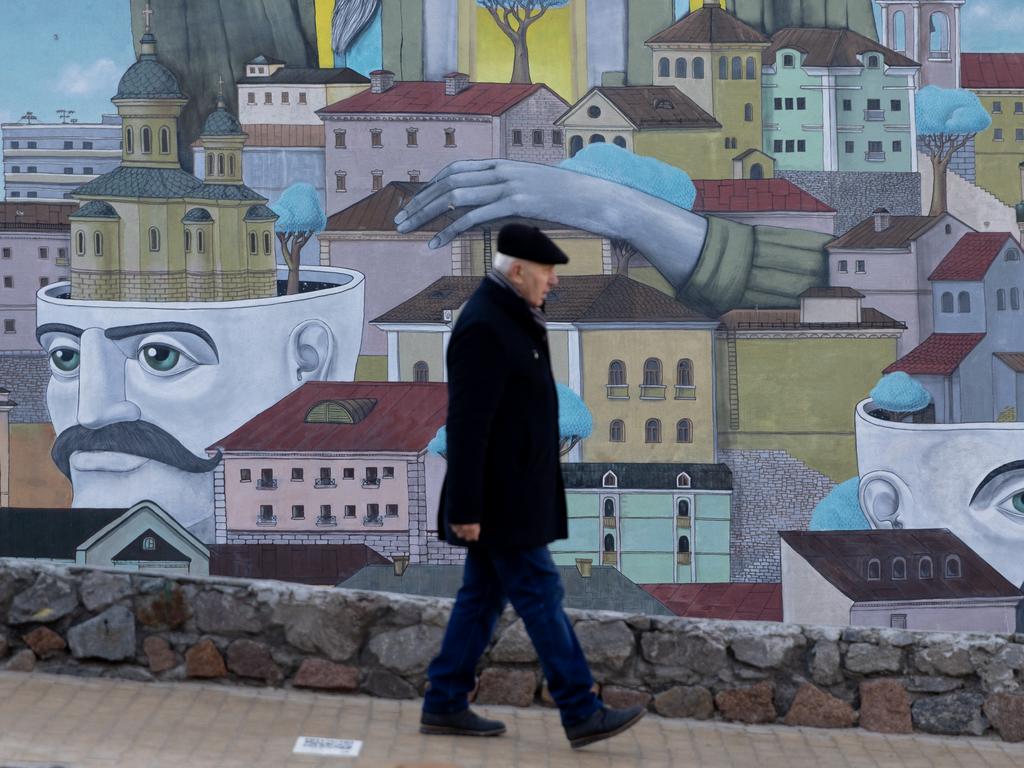 A man walks past part of a large street mural on February 15, 2022 in Kyiv, Ukraine. Picture: Chris McGrath/Getty Images