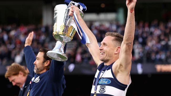 MELBOURNE, AUSTRALIA - SEPTEMBER 24: Joel Selwood of the Cats and Cats head coach Chris Scott celebrate with the Premiership Cup after winning the 2022 AFL Grand Final match between the Geelong Cats and the Sydney Swans at the Melbourne Cricket Ground. Both have been flagged as potential future Tasmania Devils. Photos Getty Images