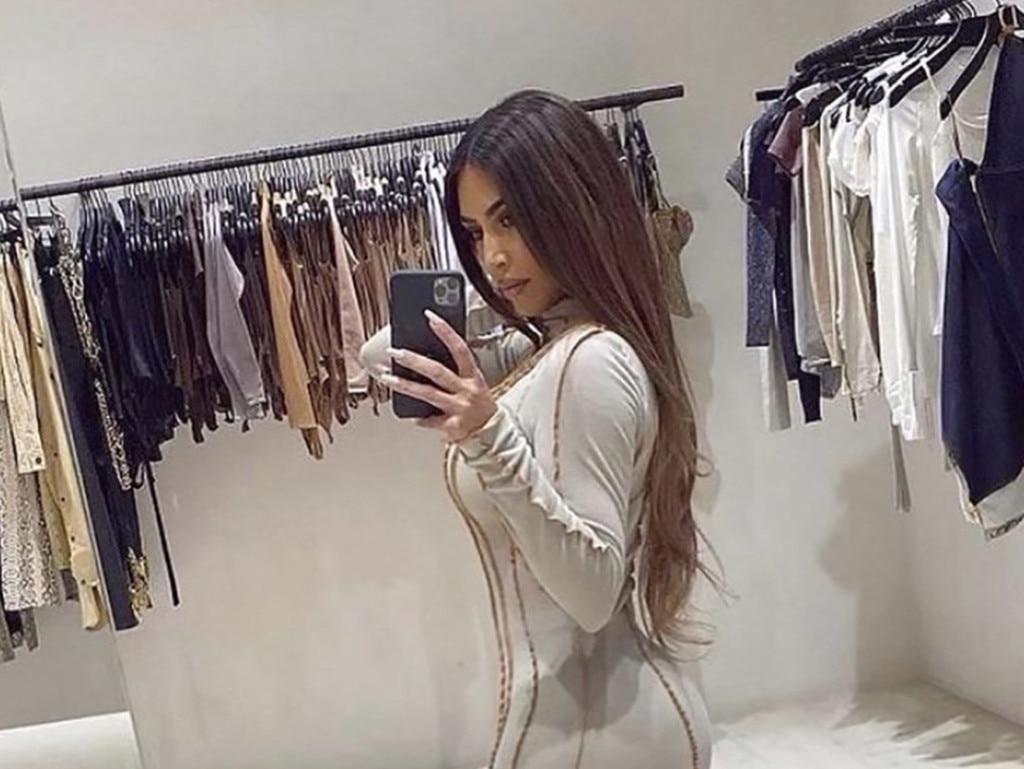 Kim Kardashian takes a selfie in Kanye’s former closet.