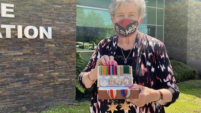 Rosemary Bowling reunited with her brother Douglas Downs' World War II service medals more than 50 years after they were stolen.